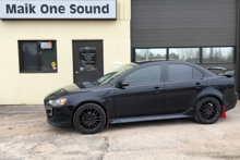 Black 2015 Mitsubishi Lancer with dark privacy window tint